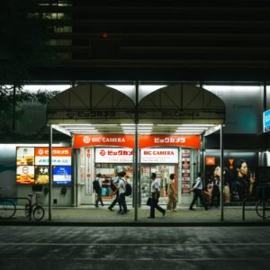 a group of people walking down a street at night